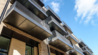A low angle image of an apartment block's balconies